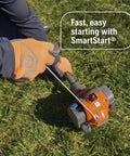 Person starting 122RJ Gas Powered Brushcutter With Multi Purpose Yard Tool String Trimmer Head And Grass Blade on grass