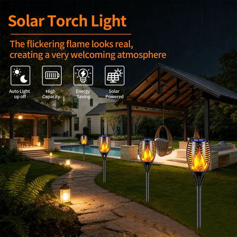 Six Pack Solar Torch Lights With Realistic Flickering Flame installed along a garden pathway at night, illuminating a patio.