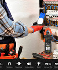 Technician using 6000 Count Bluetooth Clamp Meter With TRMS Digital Multimeter For AC DC Voltage and current testing on circuit board.