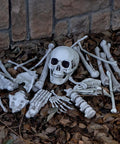 28 Piece Skeleton And Skull Halloween Decor Kit with realistic bones on leaves for indoor outdoor spooktacular haunt yard props