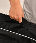 Close-up of hand gripping handle on Ultimate Fencing Gear Bag For Longswords And More, 55 Inch Waterproof 1680D Oxford Cloth Carry Bag
