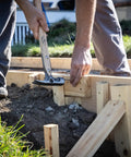 Builder using 16oz Titanium Framing Hammer With Magnetic Nail Holder And Smooth Face on wooden structure outdoors