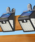 No Sweat Clip On Solar Lights Outdoor, 600 Lumens Motion Sensor Fence And Railing Spots mounted on wooden fence.