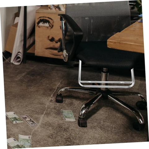 Robust Stainless Steel Retractable Office Chair Footrest Smooth Flip Down Leg Rest under a black office chair with scattered cash.