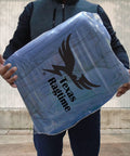 Man holding package of Blue Industrial Cloth Rags for Auto Mechanics and Janitorial Work, Heavy Duty, Low Lint, Durable and Reusable