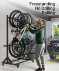 Man using Freestanding Bike Storage Rack for Five Bikes With Built Tough Heavy Duty 350 Lbs Vertical Stand in garage