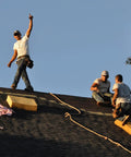 Heavy Duty Roofing Cushion With Killer Traction And Heat Blocking Kneeler Mat For Hardworking Roofer Crew on a steep roof.