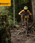 Cyclist on mountain trail wearing yellow gear, using Mountain Bike Inner Tubes 29 By 1.75 To 2.50 Inch Tires 47 622 To 62 622.