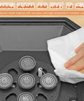 Close-up of a burner grate being wiped clean from the Two Burner Propane Camping Stove 34000 BTU Foldable Outdoor Gas Stove