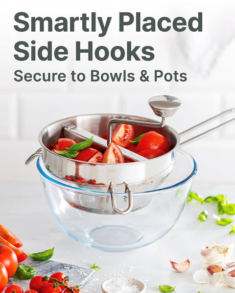 Ergonomic Hand Crank Food Mill With 3 Stainless Steel Discs for Tomato Sauce Applesauce Baby Food Mashed Potatoes Puree And Canning Smooth Texture From Fine To Coarse No Fuss Kitchen Essential For Home Cooks shown on glass bowl with tomatoes.