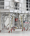 Heavy Duty 8x2 Inch Scaffolding Wheel Set Of 4 With 4400 Lb Capacity attached to metal scaffolding in industrial setting
