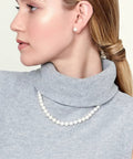 Woman wearing Go-To Japanese Akoya Pearl Necklace For Women With 8.0-8.5mm White Cultured Pearls, 18 Inch Princess Length, AAA Grade, 14K White Gold Clasp, Classic Fine Jewelry Gift For Her.