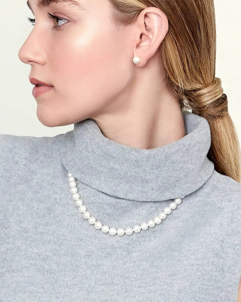 Woman wearing Go-To Japanese Akoya Pearl Necklace For Women With 8.0-8.5mm White Cultured Pearls, 18 Inch Princess Length, AAA Grade, 14K White Gold Clasp, Classic Fine Jewelry Gift For Her.