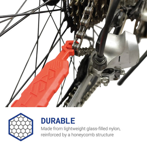 Red quick fix bike tool attached to chain and gear, made from lightweight glass-filled nylon, showing Get Your Chain Back On Your Bike In Three Seconds Without The Mess Quick Fix For Bike Maintenance On The Go Attaches To Your Bike Ready For MTB And Commuter Use Great Gift For Dads Christmas Stocking Filler