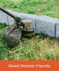 Close-up of weed wacker trimming grass along landscape edging kit with faux stone blocks for lawn borders and flower beds 10 pack with 20 spikes greystone look for no sweat easy install includes 48 inch long sections each section has 6 blocks.