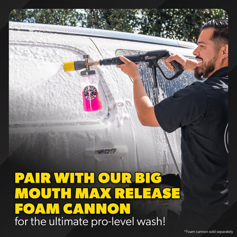 Person using a pressure washer with foam cannon attachment on a van