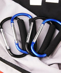 4 Pack Large 5.5 Inch D Style Carabiner Hooks With Foam Cushioned Handles For Pain Free Carrying And Everyday Use In Grocery Trips, Travel, And Stroller Runs Black And Blue placed on a fabric surface