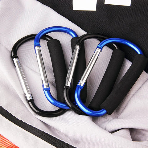 4 Pack Large 5.5 Inch D Style Carabiner Hooks With Foam Cushioned Handles For Pain Free Carrying And Everyday Use In Grocery Trips, Travel, And Stroller Runs Black And Blue placed on a fabric surface