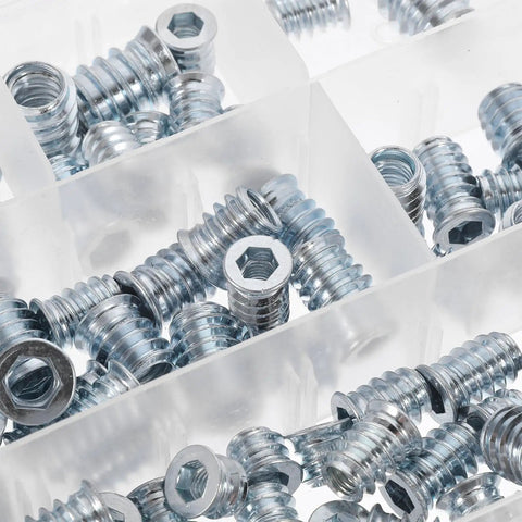 Close-up of zinc-plated iron inserts from Threaded Inserts Kit For Wood Projects 100 Pieces Beefy Zinc Plated Iron Fasteners