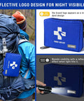 Grab And Go Compact Waterproof First Aid Kit With Nine Organized Compartments 300 Piece Emergency Supplies Set shown secured to backpack and with reflective logo.