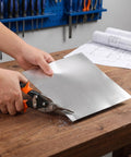 Hands cutting 6 Pack Aluminum Sheet Set For DIY Crafts And Model Making Thin Flat Metal Panel Flexible For Engraving Stamping And Bending In The Workshop For Your Maker Projects 7.87 By 7.87 Inches with snips on a workbench