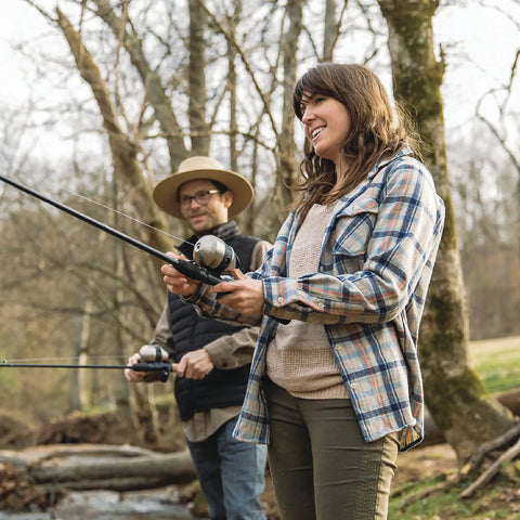 Two people using Two Pack Spincast Fishing Rod And Reel Combos With 5 Foot 6 Inch 2 Piece Fiberglass Rods Quickset Anti Reverse Reels