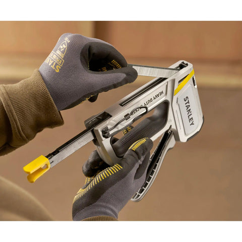 Person loading a Heavy Duty Staple And Brad Gun For Fast, Precise Fastening In Woodworking And Upholstery Projects, Durable Multi Color Tool In Hand.
