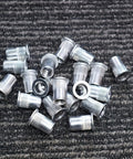 335 Piece Rivet Nut Kit With Seven Metric Sizes M3 To M12, carbon steel zinc-plated nuts on a textured surface