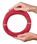 Man holding coiled Six Gauge Premium Extra Flexible Welding Cable 600 Volt Red 25 Feet Made In USA Sunlight Resistant Water Resistant