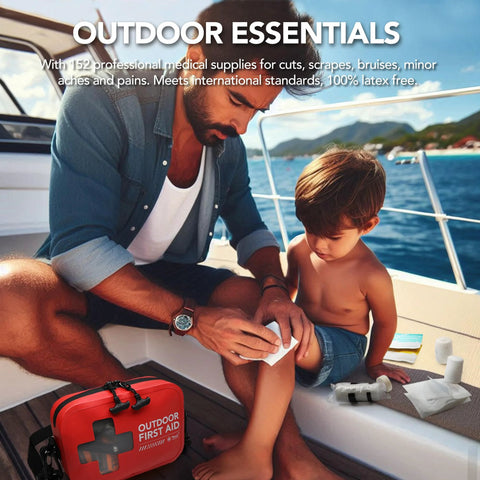 Front view: red 152-piece waterproof outdoor first aid kit on a boat; man bandages a child's knee