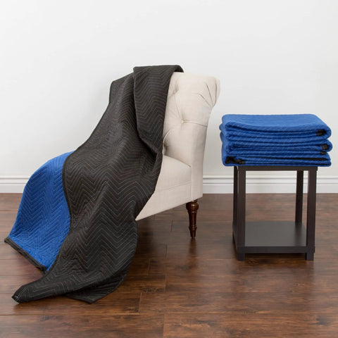 Heavy Duty Moving Blanket 80 By 73 Point 5 Inches Reusable Quilted Furniture Pad Draped Over a Chair with Stacked Pads