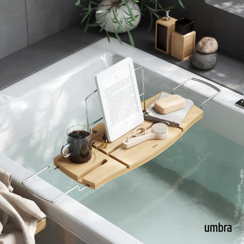 Aquala Extendable Bathtub Tray Caddy With Book Stand And Wine Glass Holder, holding tablet and bath accessories in a spa setting