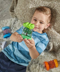 Child holding green spring Seasonal Sensory Tubes For Calming Kids, Chill Out Fidgets For Travel And School, Hands On Stress Relief Toy.