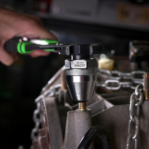 Durable Universal Stud Extractor For Damaged Bolts And Broken Studs, Fits 1/4 To 1/2 Inch Studs in use with a wrench on an engine block