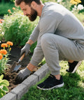 Person gardening with Heavy Duty Garden Edge Borders 16 Pack No Dig Lawn Edging, separating flowers from lawn
