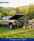 Tough As Nails 29 Inch Gas Struts For SnugTop Truck Bed Covers With 85 Pound Shock Spring And 13 Mm Ball Socket Compatible With Snuglid Snugfit Tonneau Cover swap pair, displayed behind family enjoying outdoor activities.