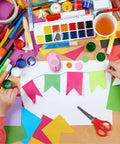 Child crafting with paper, paint, and 5 Piece Craft Hole Punch Set For Scrapbooking And Card Making, pink circle shapes visible.