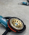 Universal 7 Inch Dust Shroud For Angle Grinders With Vacuum Hose Adapter Fits Most Major Brands on a concrete surface
