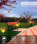 Sun Powered Solar Torch Lights Outdoor Flickering Flame 3 In 1 Detachable Hanging Lanterns No Wiring Auto On Off IP65 Waterproof Tiki Torches For Garden Path Patio Yard Decor 6 Pack lighting a garden path in rain.