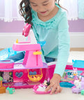 Child playing with Minnie Mouse Bowdazzling Yacht Lights And Sounds Playset With 16 Piece Figures And Accessories Pink Boat