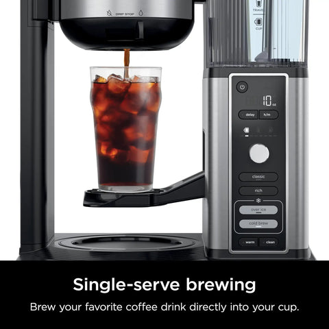 Hot And Iced XL Coffee Maker With Rapid Cold Brew Four Brew Styles Eight Cup Sizes From Small Cup To Travel Mug Barista Grade Single Serve Brewer 12 Cup Carafe Permanent Filter Removable Reservoir Black CM371, front view showing iced coffee brewing in a tall glass.