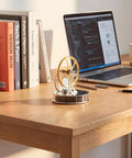 Low Temperature Stirling Engine Model Kit showcasing heat to power with glass cylinder on a wooden desk beside a laptop.
