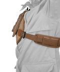 Side view of adjustable rifle and shotgun shoulder shield with leather recoil pad, brown suede leather cushion, waxed canvas shell.