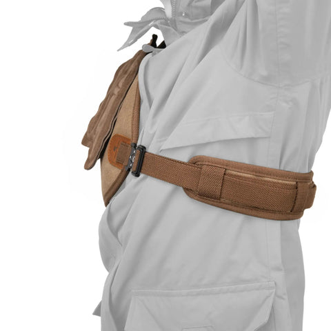 Side view of adjustable rifle and shotgun shoulder shield with leather recoil pad, brown suede leather cushion, waxed canvas shell.