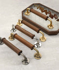 Two Pack Walnut Wood Door Pull Handles With Antique Nickel Backplates shown with brass accents and smooth polished grip handle design