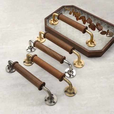 Two Pack Walnut Wood Door Pull Handles With Antique Nickel Backplates shown with brass accents and smooth polished grip handle design