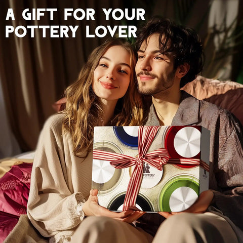 Two people smiling while holding a gift-wrapped box labeled for pottery lovers, featuring bright colors and ribbon.