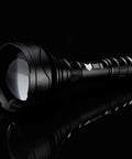 Side view of XB10 Infrared Torch For Night Vision Gear 5W IR Illuminator 940nm with 67mm aspherical lens on black background