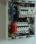 Automatic Aerosol Fire Suppression Kit For Electrical Cabinets And Control Panels Boasting Thermal Activation And Zero Drama Flame Stopping In A Compact Self Triggering Guard mounted next to electrical circuit breakers.