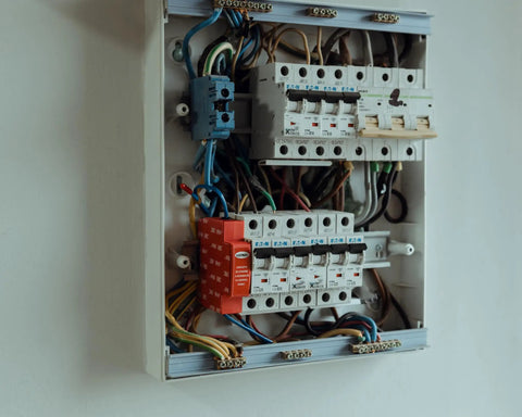 Automatic Aerosol Fire Suppression Kit For Electrical Cabinets And Control Panels Boasting Thermal Activation And Zero Drama Flame Stopping In A Compact Self Triggering Guard mounted next to electrical circuit breakers.